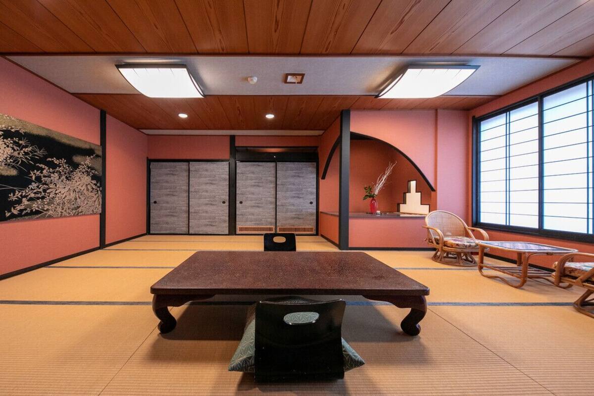 A tatami mat room with a low table, sliding doors, and traditional Japanese furniture.