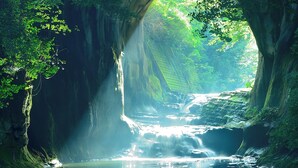 A natural cave entrance with a stream flowing through it.