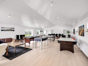 A spacious room with a pool table, foosball table, and a ping pong table. - 4 Star Holiday Home in Lokken (Lokken)