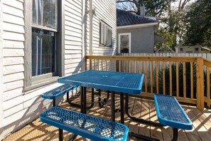 A wooden deck with a blue metal table and benches. - Heart of Downtown, Shops & Dining - Cozy Craftsman (Columbus)