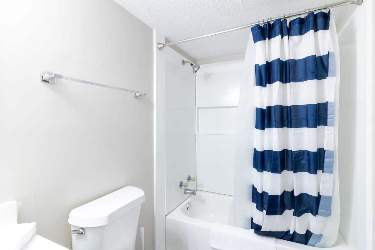 Ein Badezimmer mit Toilette, einer Badewanne und einer Duschvorhang.