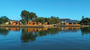A waterfront property with multiple buildings, a dock, and a calm lake. - Suikeisyoku No Shiteiseki Koya (Yurihama)