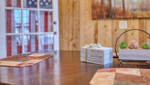 A wooden interior with a wooden door, a framed picture on the wall, and a small wooden box with a message on it. - Mins to Fort Benning - The Columbus Cottage Guesthouse (Columbus)