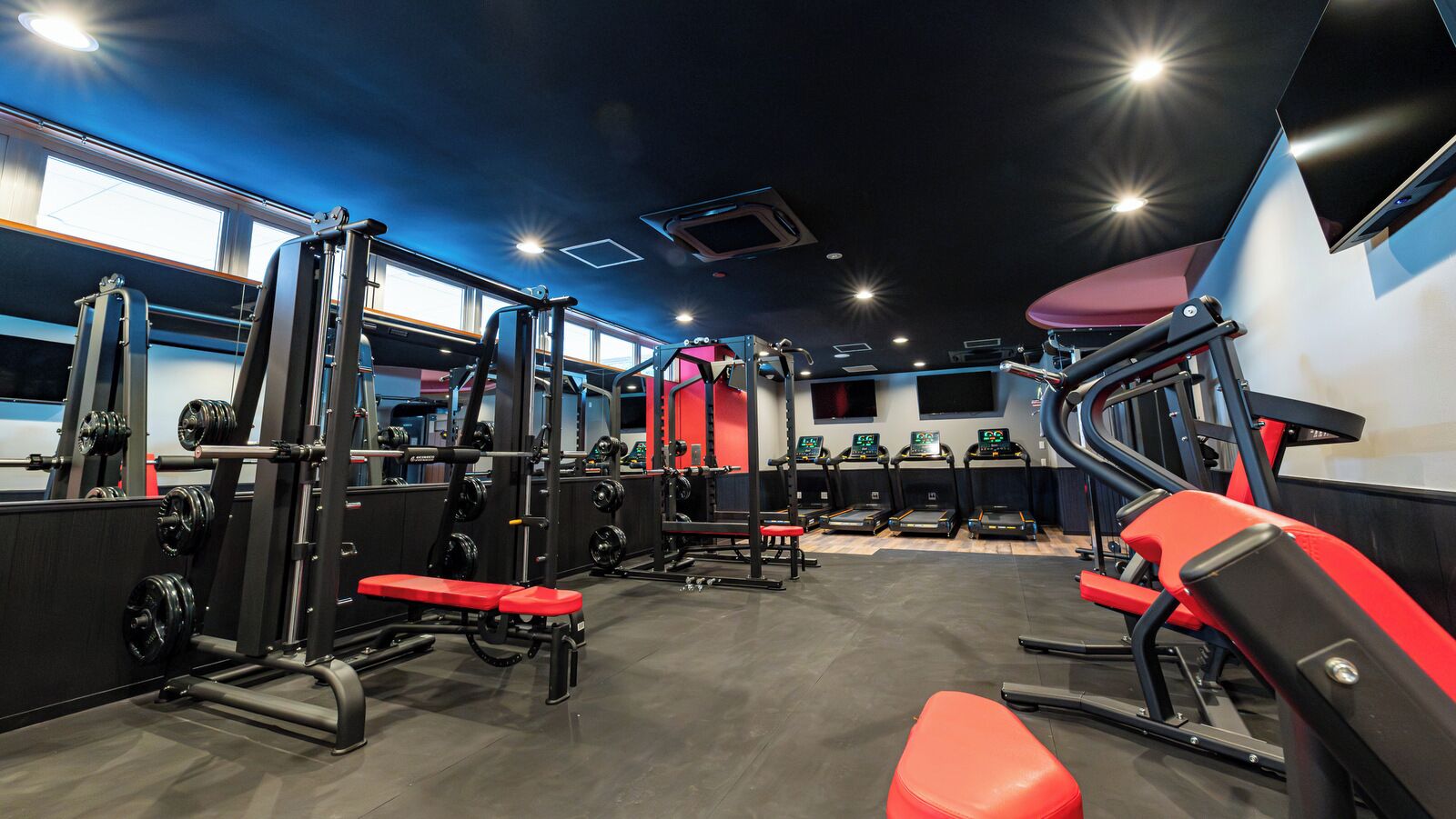 A gym with exercise equipment, treadmills, and weight machines.