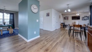 A spacious living area with a dining table, chairs, a clock, and a ceiling fan. - Pet-Friendly House Near Ft Benning w/ Free Parking (Columbus)