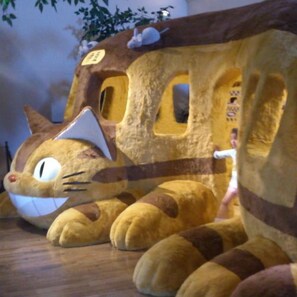A plush toy resembling a cat with a house-like structure, possibly a toy or decoration. - Izukogen Hanairotei (Ito)