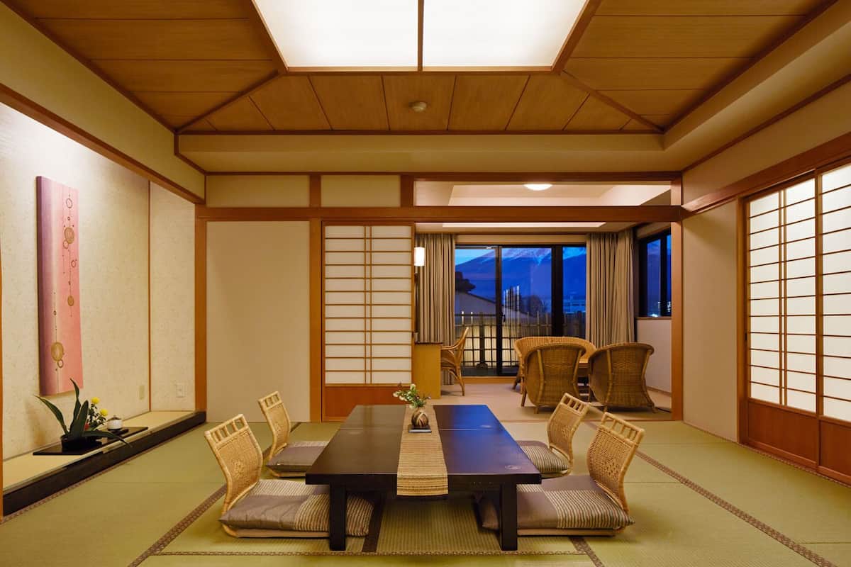 A traditional Japanese-style room with tatami flooring, a low table, and shoji screens.