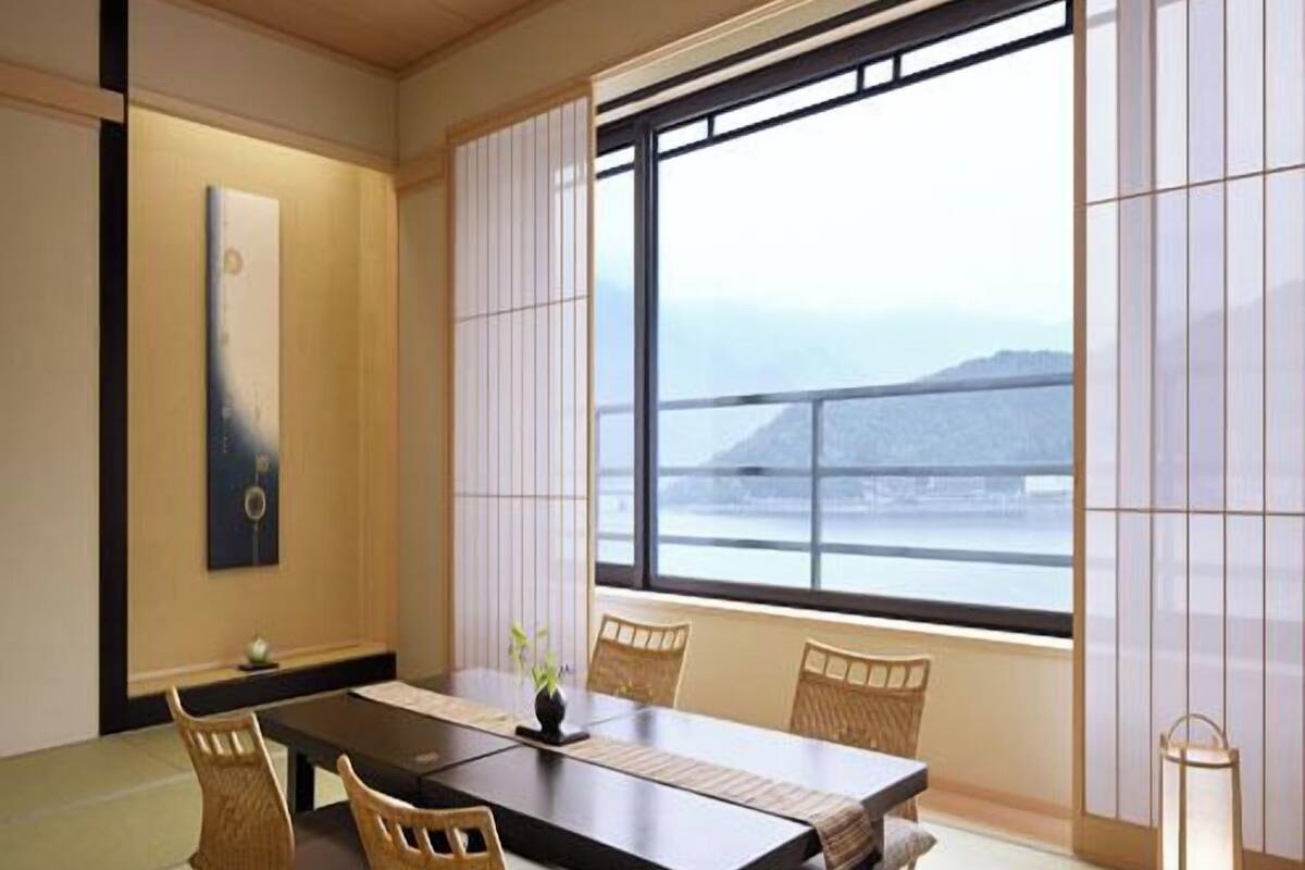 A traditional Japanese room with tatami flooring, a low table, and shoji screens.
