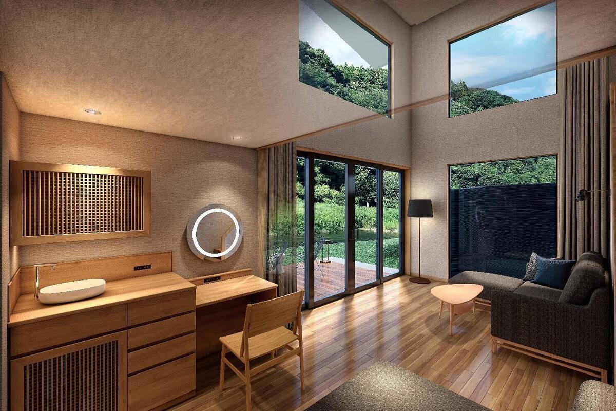 A modern bathroom with a wooden vanity, a round mirror, and a large window.