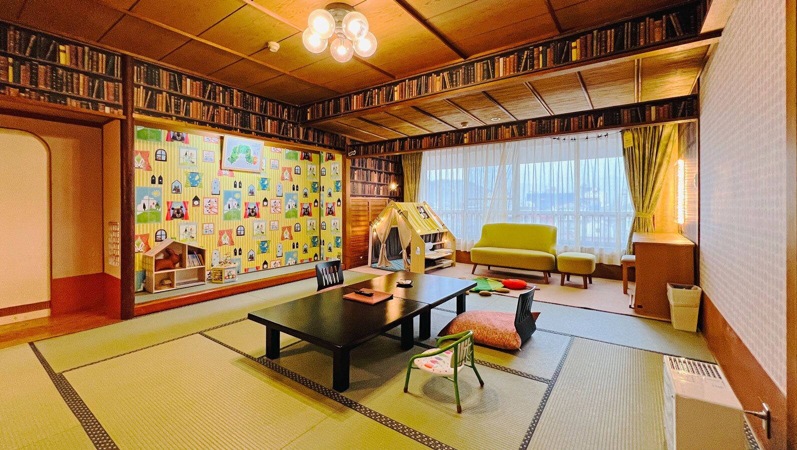 A traditional Japanese-style room with tatami flooring, a low table, chairs, a bookshelf, and a sliding door.