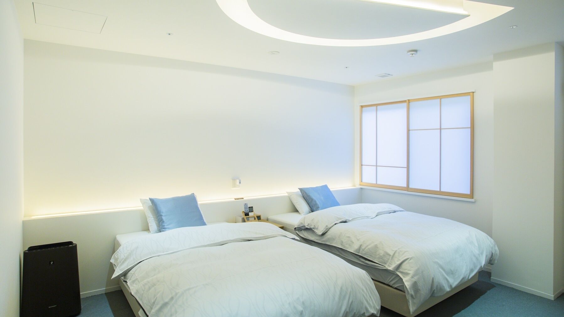 A modern hotel room with two beds, a large window, and a unique ceiling design.