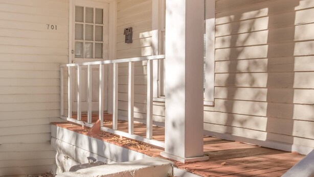 A porch with white railings, a door marked '701', and a brick base. - Pet-Friendly Duplex Near Riverwalk w/ Free Parking (Columbus)