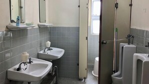 A men's restroom with two sinks, urinals, a mirror, and a toilet. - Shirahama Onsen Minshuku Kotobuki (Shirahama)