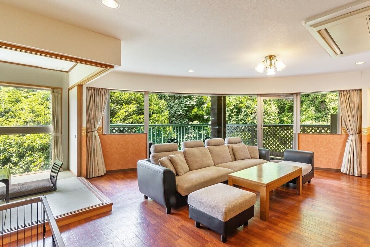 A modern living room with a sectional sofa, a coffee table, and a TV.