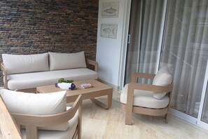 A modern living area with a sofa, two armchairs, a coffee table, and a brick wall. - ®{Terrenas~Beach~Spot} Monserrat +Pool+5min Beach (Las Terrenas)