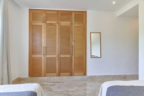 A bedroom with a large wooden wardrobe, a mirror, and two beds. - ®{Monserrat Beach Condo} @Terrenas +Pool+Wifi+BBQ (Las Terrenas)