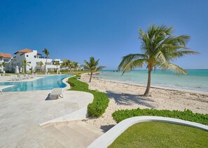 A resort with a swimming pool, beach, and palm trees. - ®The{Beach~Spot} @CapcanaParadise +Pool+Beachfront (Punta Cana)