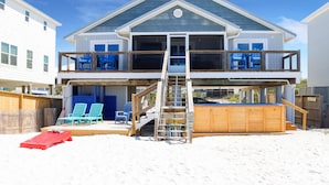A two-story house with a balcony, a wooden deck, and a pool. - My Tide (Port St. Joe)
