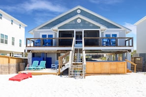 A two-story house with a balcony, a wooden deck, and a pool. - My Tide (Port St. Joe)