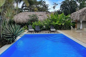 A swimming pool with lounge chairs and tropical plants. - 4BR{Beach~by~Melo} @LosNomadas +2Min Beach+Pool (Las Terrenas)