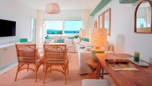 A modern living room with a sofa, chairs, a wooden table, and a TV. - Genteel Home Playa Rocio (Marbella)