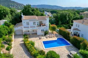 A two-story house with a swimming pool, stone pathway, and surrounding greenery. - Villa Friesland – Pleasant Villa with Pool in a Peaceful Setting (Calonge)