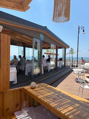 Outdoor dining. Paguro Beach Hotel