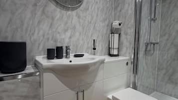 Shower, towels, soap, toilet paper