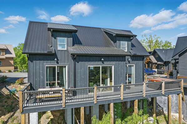 A two-story house with a deck, large windows, and a garage. - Lakeview Cabin on Douglas Lake (Sevierville)