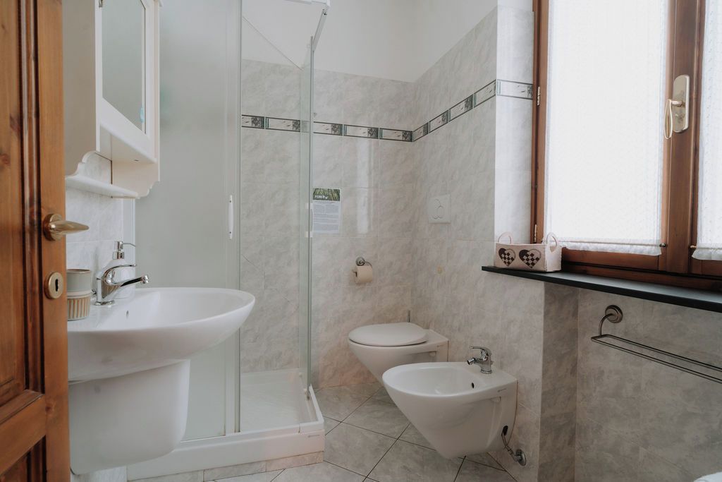 Un baño con ducha, lavabo, inodoro y bidé.