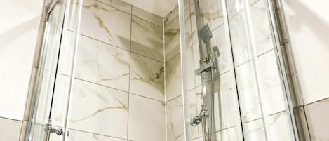 Shower, hair dryer, towels, shampoo