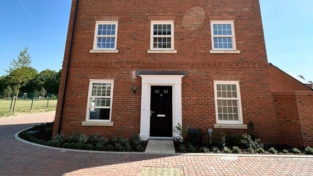 A red brick building with a central entrance, multiple windows, and a paved driveway. - Brampton Park (Brampton)