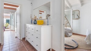 A white dresser with drawers, a mirror, and decorative items. - Holiday Home “Villa Sol Del Este, Es Castell” with Sea View, Wi-Fi and Air Conditioning (Sol del Este)