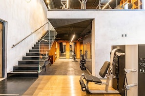 A gym with a staircase, exercise equipment, and a wooden floor. - Loft for rent in the Romantic Zone of Puerto Vallarta (Puerto Vallarta)