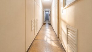 A long, narrow hotel corridor with doors on both sides, leading to individual rooms. - Comfort in Ipanema Near the Beach (Rio de Janeiro)
