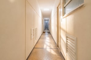 A long, narrow hotel corridor with doors on both sides, leading to individual rooms. - Comfort in Ipanema Near the Beach (Rio de Janeiro)