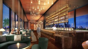 A modern bar area with seating and a city view.