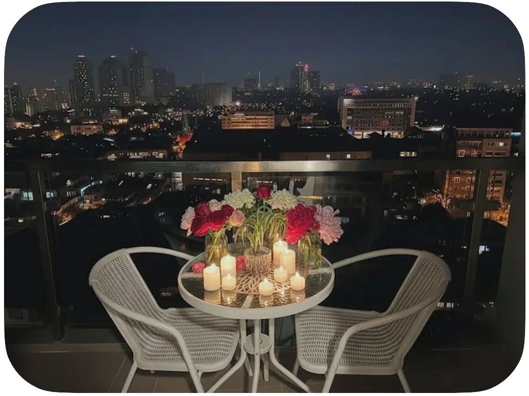 balcony,outdoor dining,dining table, unit views,couples dining,nighttime