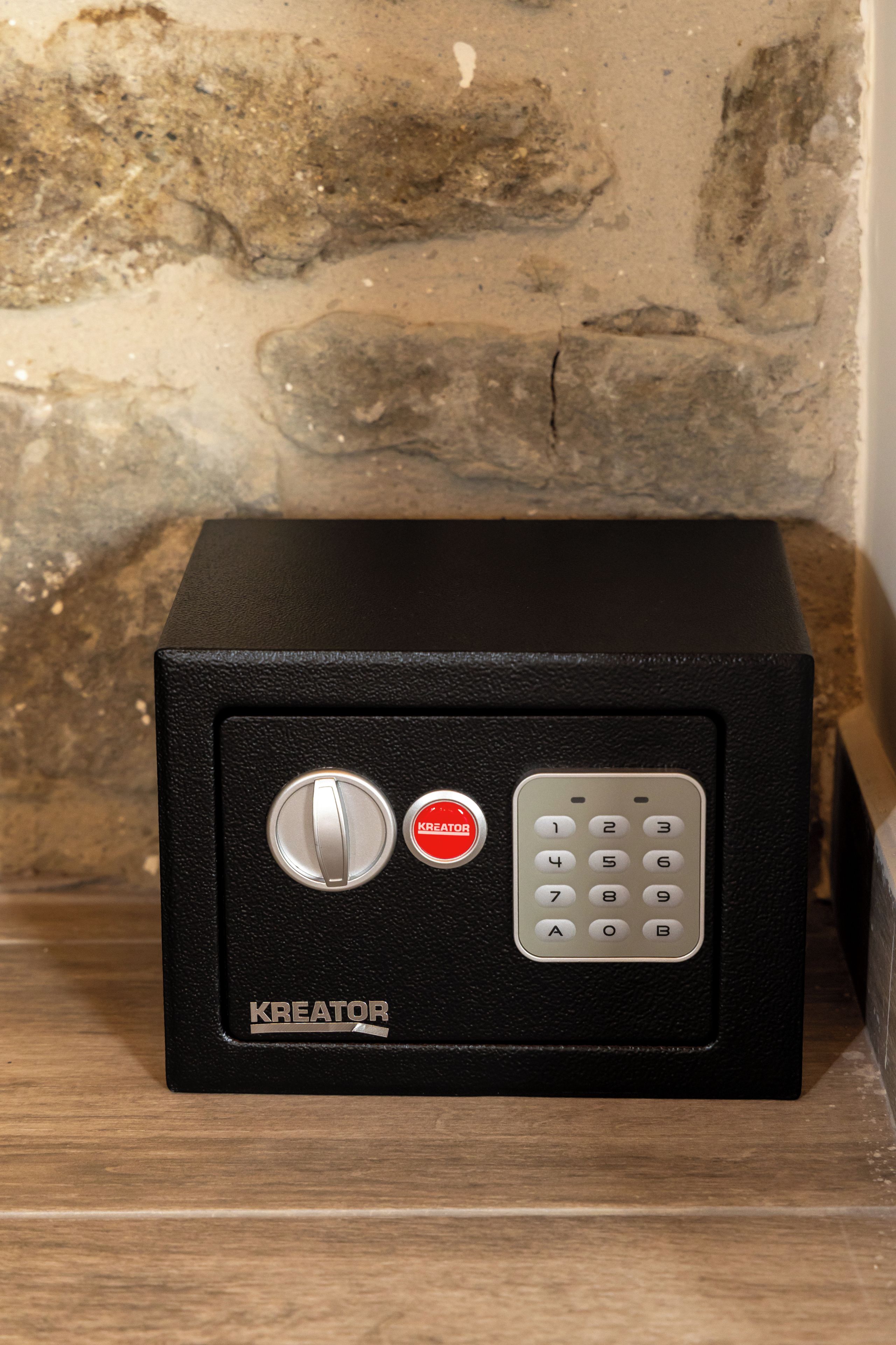 A black safe with a combination dial and a keypad, labeled 'KREATOR.'