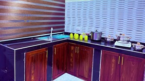 A modern kitchen with a built-in sink, wooden cabinets, and a backsplash with a striped pattern.