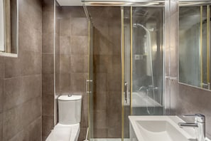 A modern bathroom with a glass-enclosed shower, a white sink, and a toilet. - Bairro Alto Typical by Homing (Lisbon)