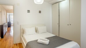 A hotel room with a bed, a wardrobe, and a desk. - Bairro Alto Typical by Homing (Lisbon)
