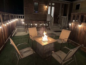 A patio with a fire pit, chairs, and a wooden deck. - Riverwalk Path! Heart of South Main w/ Peak Views (Buena Vista)