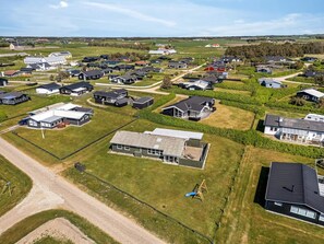 An aerial view of a residential area with houses, roads, and green spaces. - 4 Star Holiday Home in Lokken (Lokken)