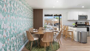 A modern kitchen with white cabinets, a microwave, and a stainless steel oven. - Sleeps 16 | Heated Pool + Arcade + Backyard Resort (Mesa)