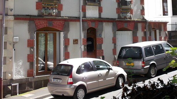 A multi-story building with a traditional architectural style, featuring a symmetrical facade, multiple windows, and a central entrance. - Bed and Breakfast 'Eugénie' with Mountain View, Shared Terrace and Wi-Fi (La Bourboule)