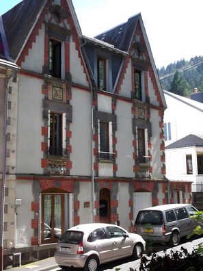 Ein mehrgeschossiges Gebäude im traditionellen Baustil, mit einer symmetrischen Fassade, zahlreichen Fenstern und einem zentralen Eingang.