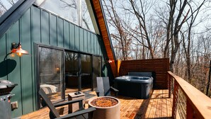 A wooden deck with outdoor seating, a hot tub, and a grill. - Oak Hollow | Hocking Hills, Hot Tub, Romantic (McArthur)
