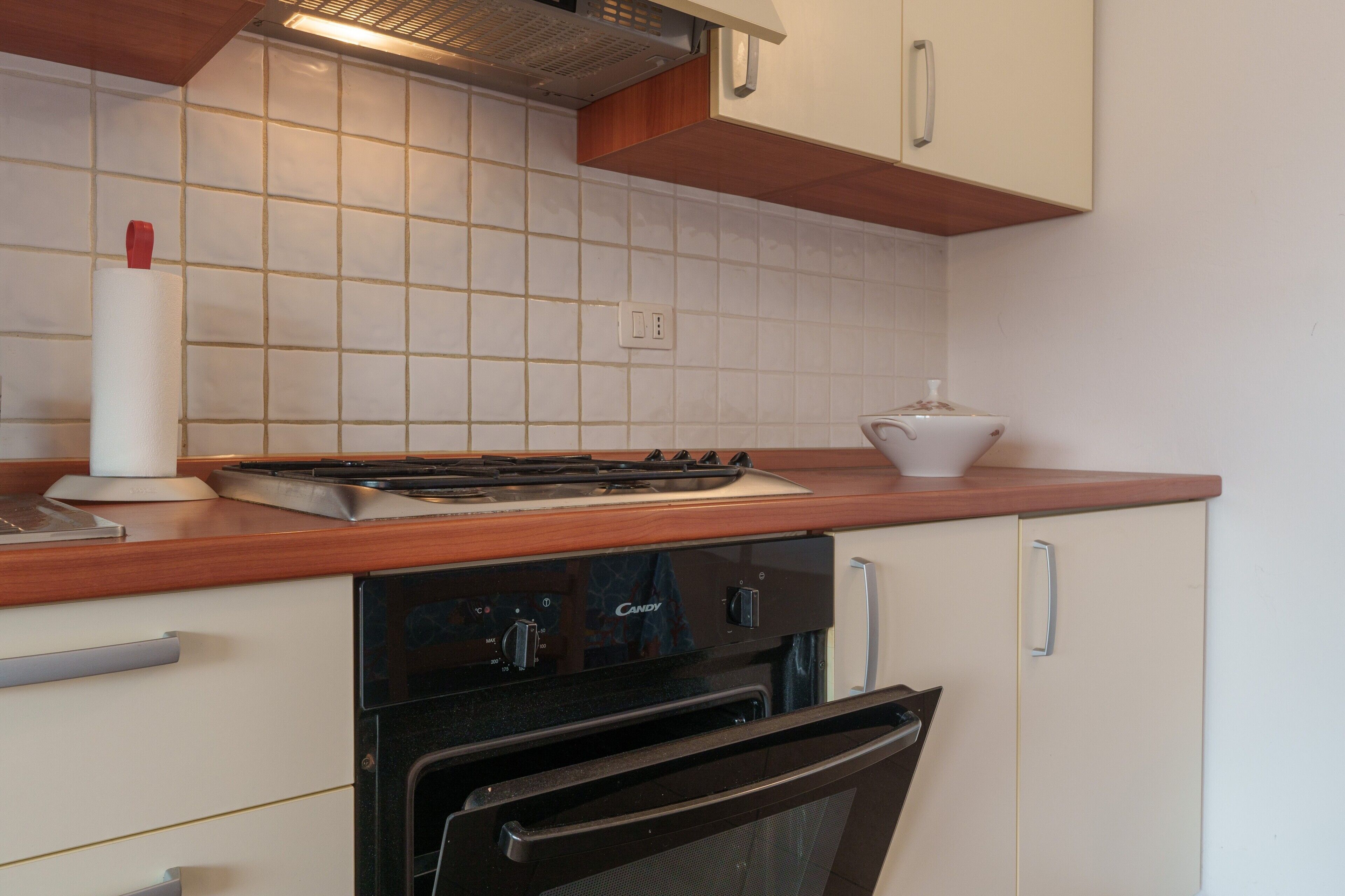 A kitchen with a stove, oven, and cabinets.