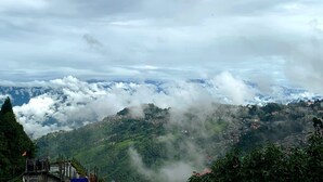 A mountainous landscape with a village nestled among the hills.